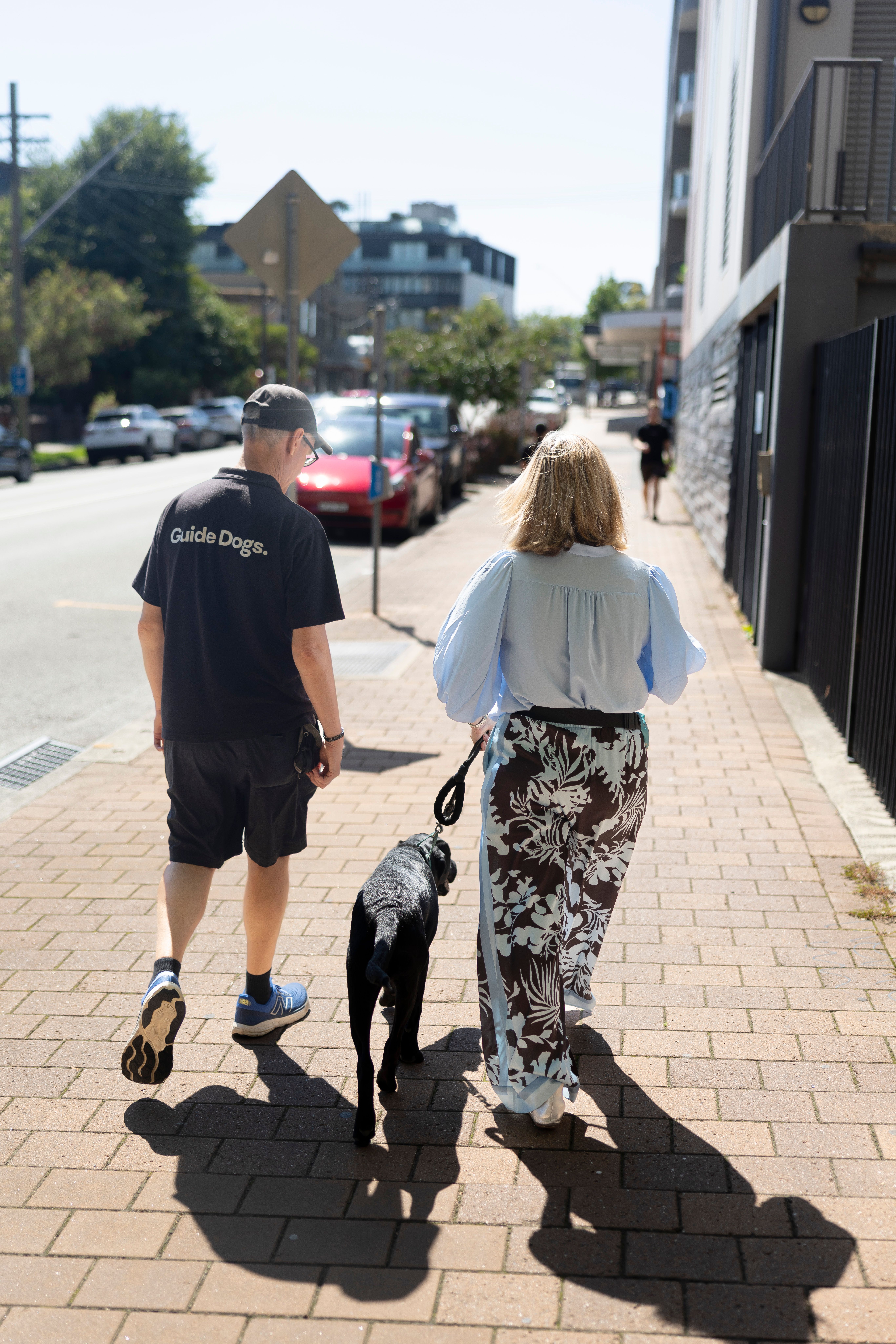 A Puppy Raiser walking with staff. 