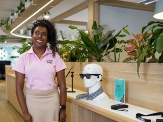 Abby standing at the AT Helpdesk and smiling.