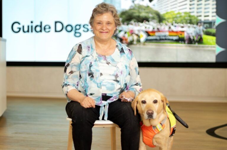 Amanda sitting next to Guide Dog Sadie.