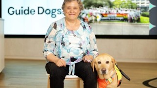 Amanda sitting next to Guide Dog Sadie.