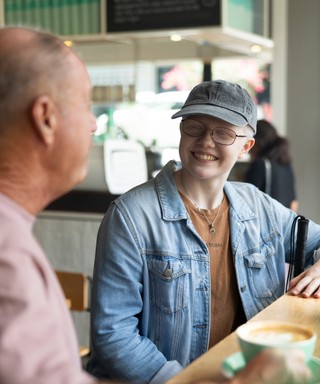 Client Zara sitting at a cafe.