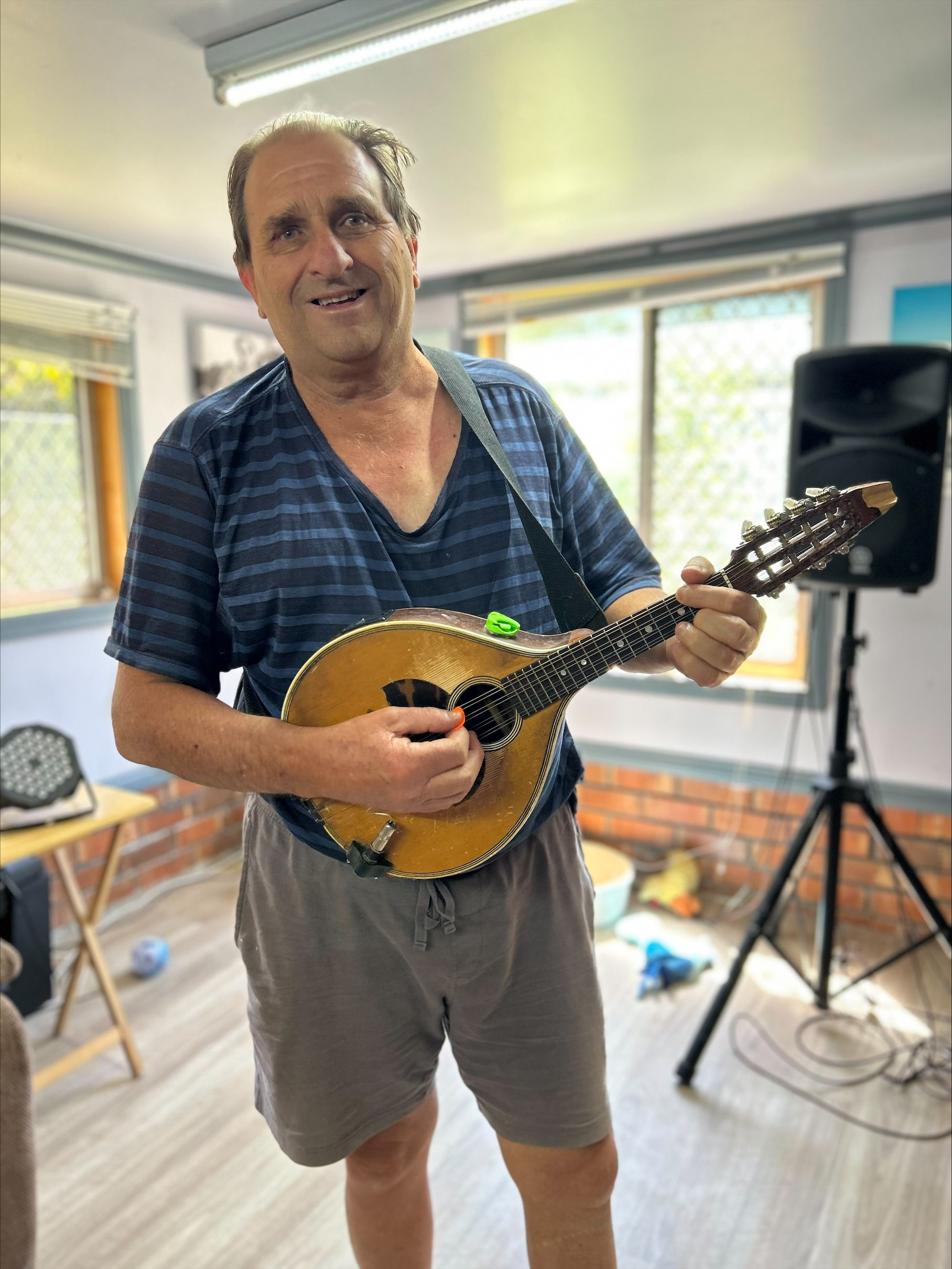Bevan standing and playing a guitar.