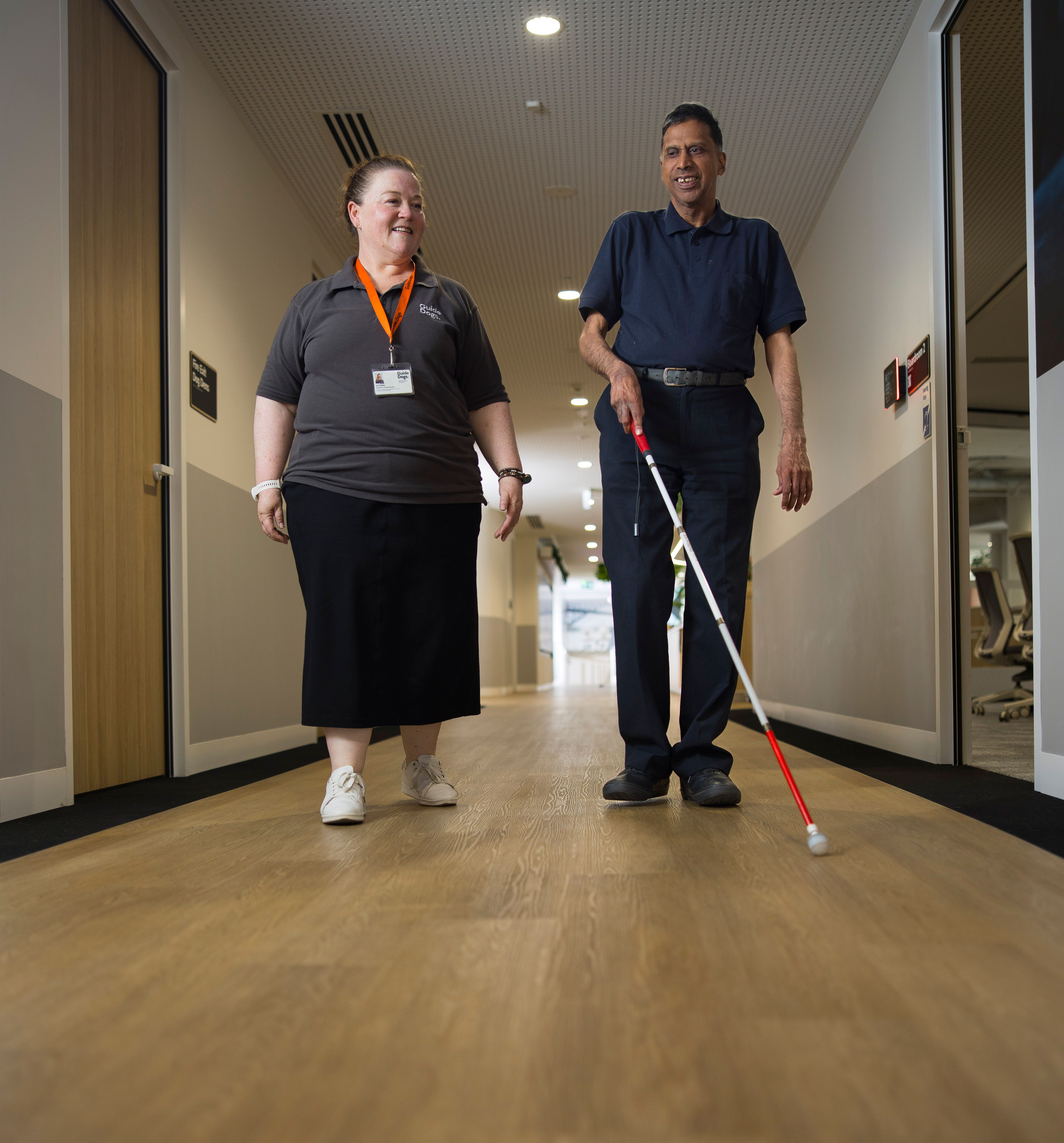 A staff member walking with a Client.
