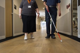 A Staff member walking with a Client.