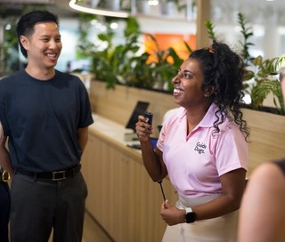 Two staff members standing and smiling.