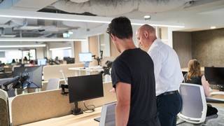 Ben Moxey and Ryan Jones setting up a computer.