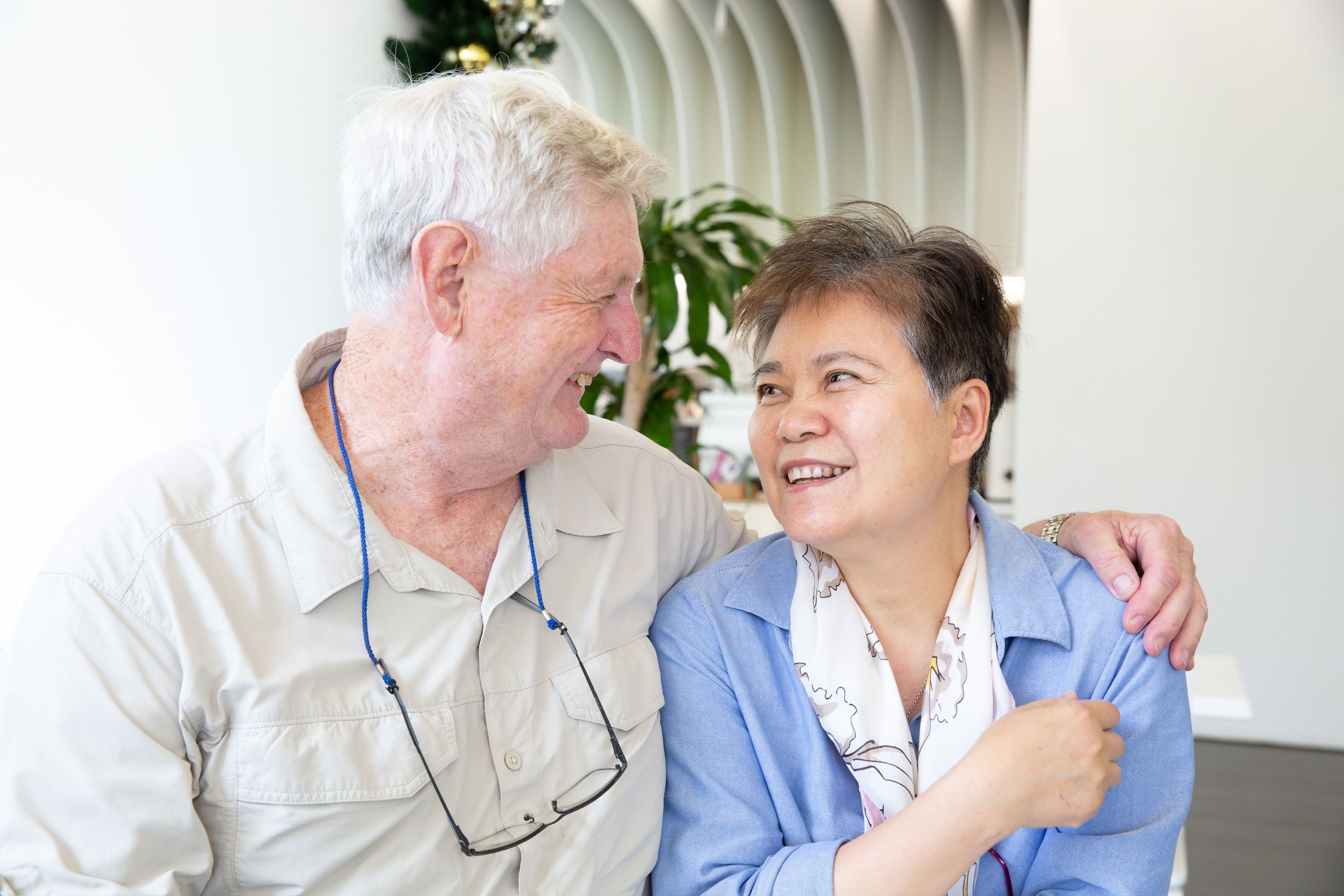 Two people sitting together smiling.