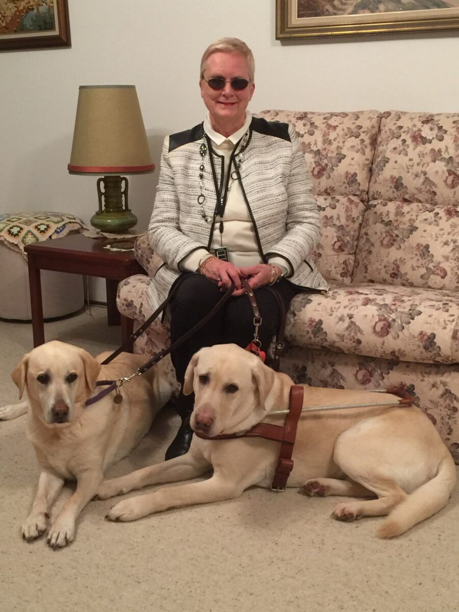 Elaine with her retired Guide Dogs.