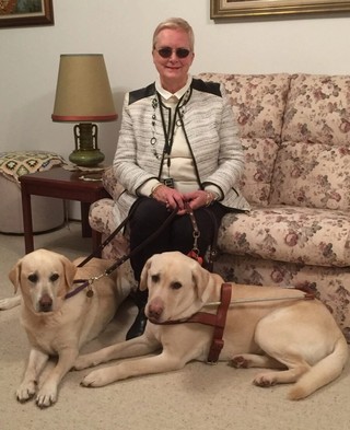 Elaine with her retired Guide Dogs.