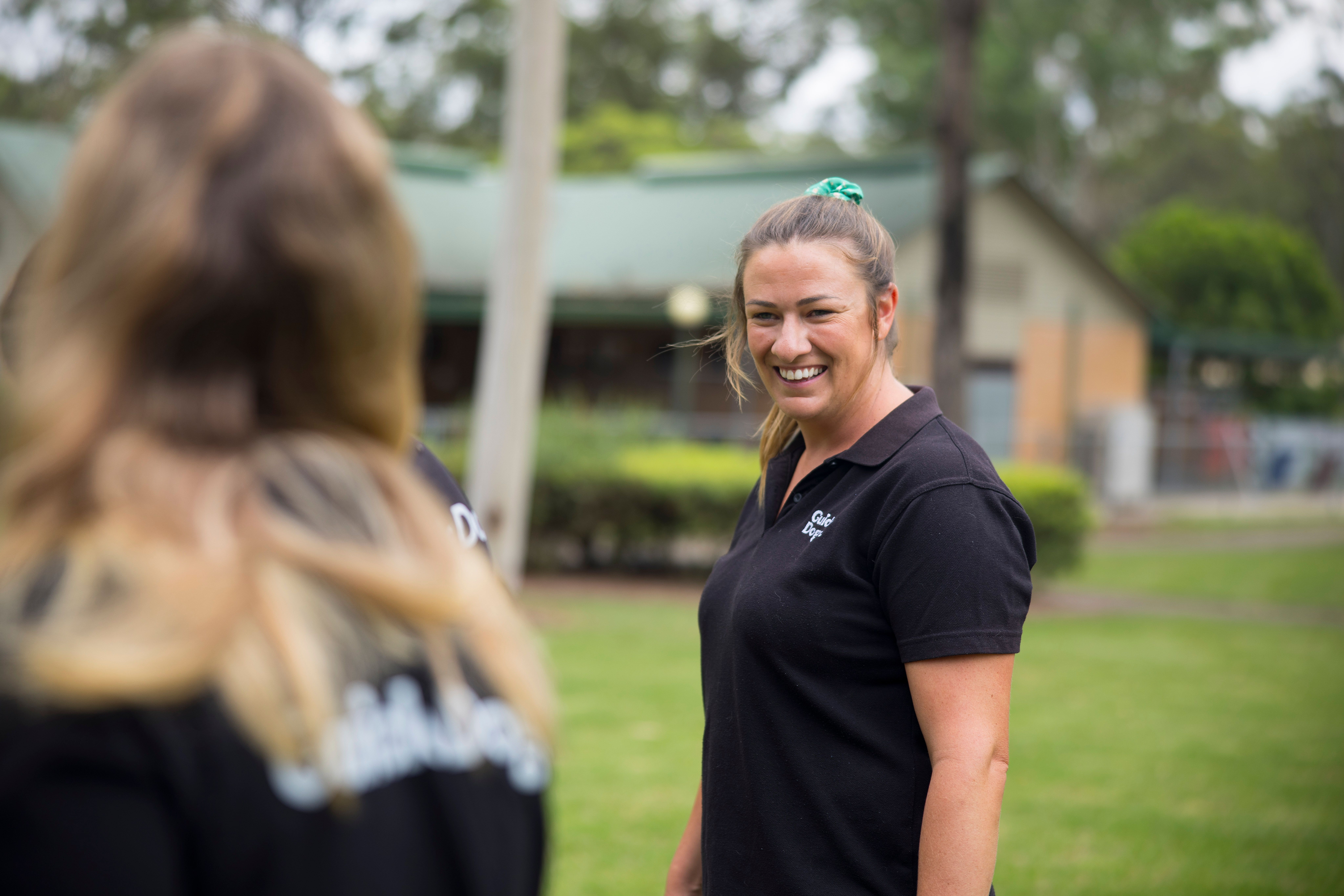 A staff member standing in a Guide Dogs uniform