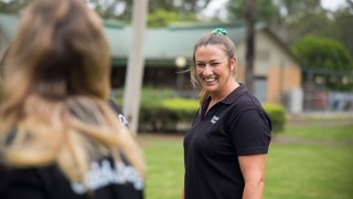 A staff member standing in a Guide Dogs uniform
