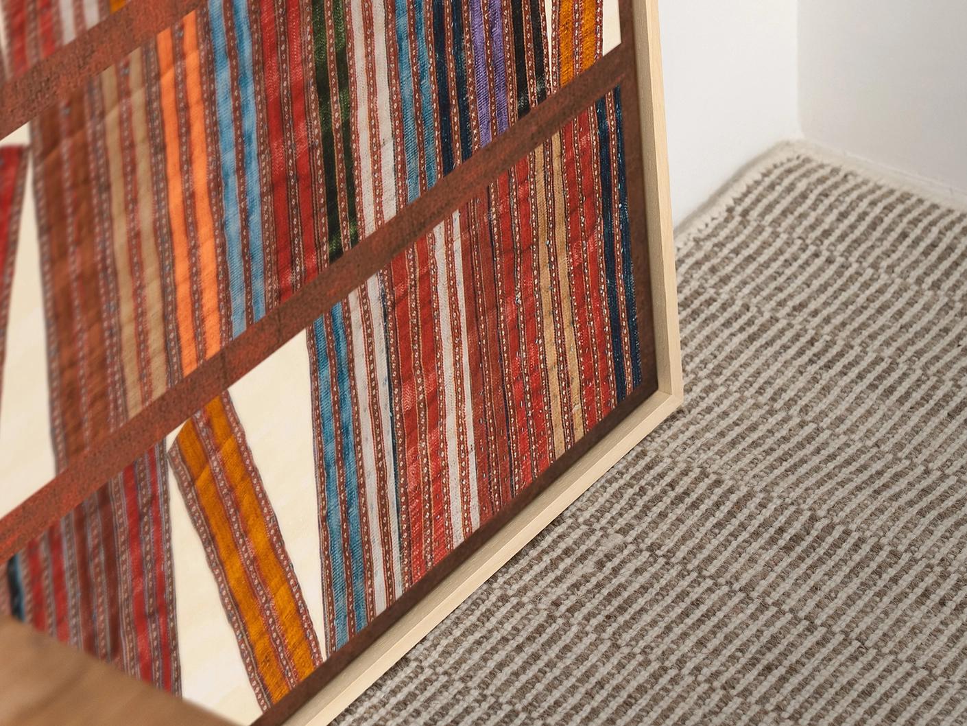 Books canvas in rust, blue and multicolour, shown in a lifestyle close-up as image 2