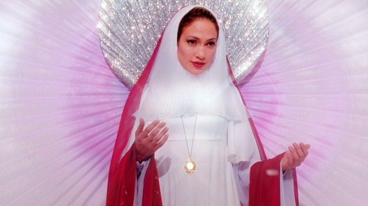 Jennifer Lopez er kledd og poserer som en slags Jomfru Maria, med et stort diamantskjell bak henne