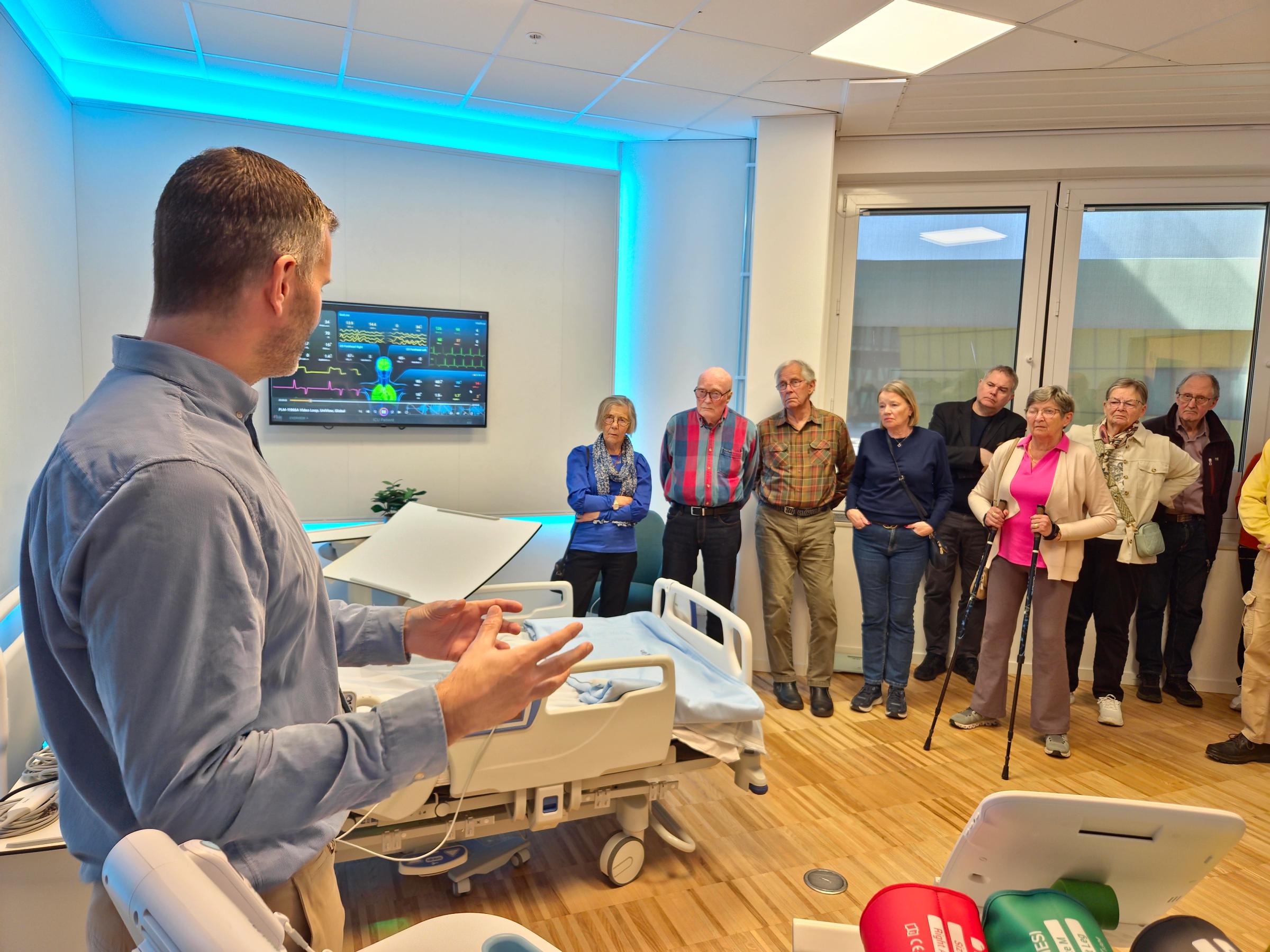 Besöksgrupp i showroomet för e-hälsa som lyssnar till Henrik Allberg, e-hälsoexpert
