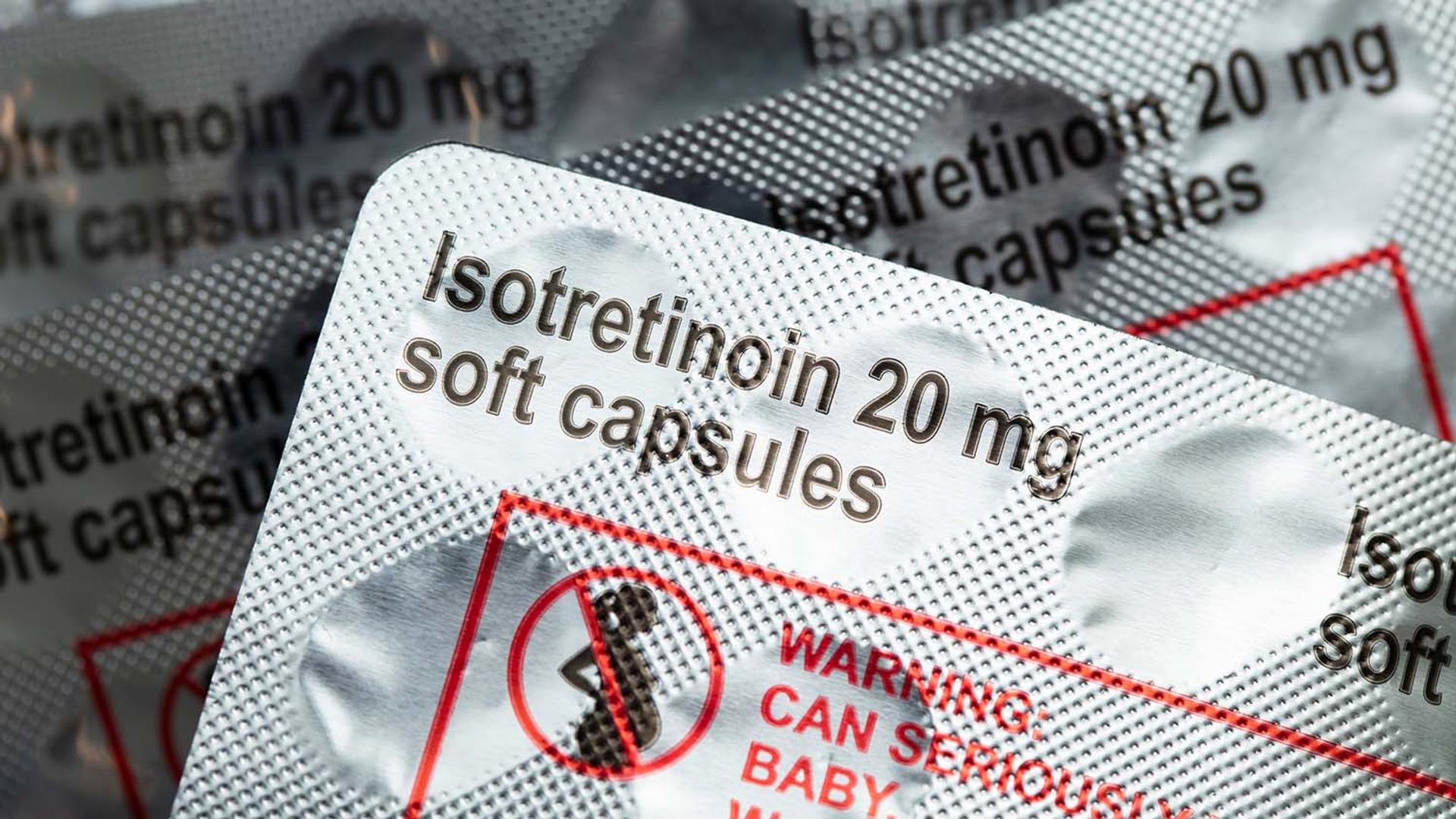 Blister packs of Isotretinoin 20 mg soft capsules with a pregnancy warning symbol.