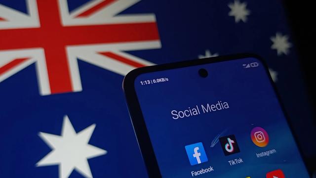 A smartphone screen shows social media apps over a blurred Australian flag.