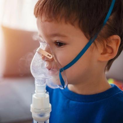 Young boy using a nebulizer treatment for respiratory therapy