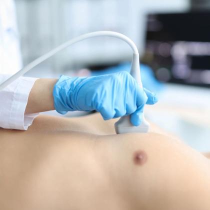 Healthcare professional performing an ultrasound exam on a patient's abdomen