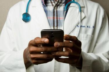 Doctor Holding Cell Phone.