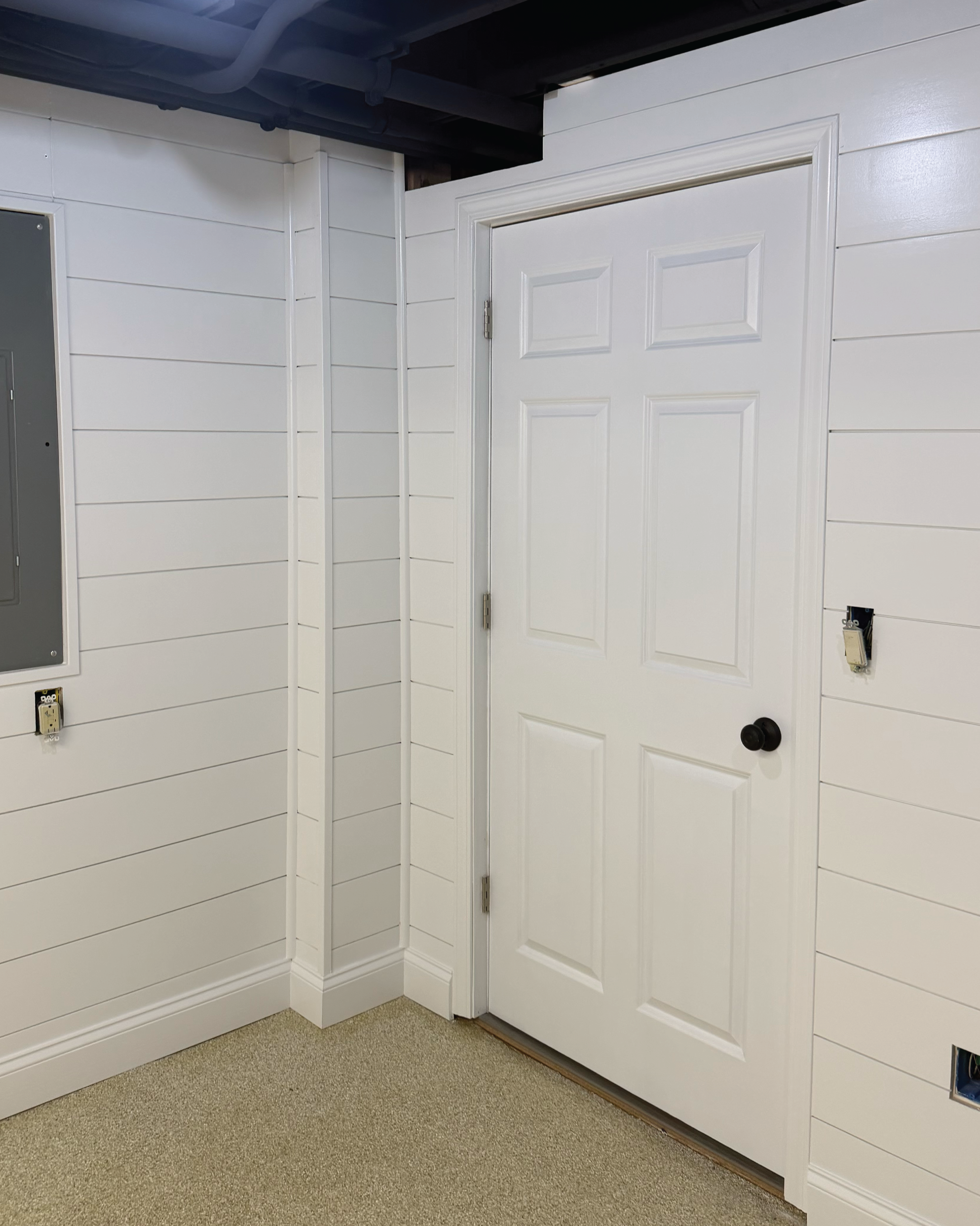 Residential home's basement walls, shiplap install and paint