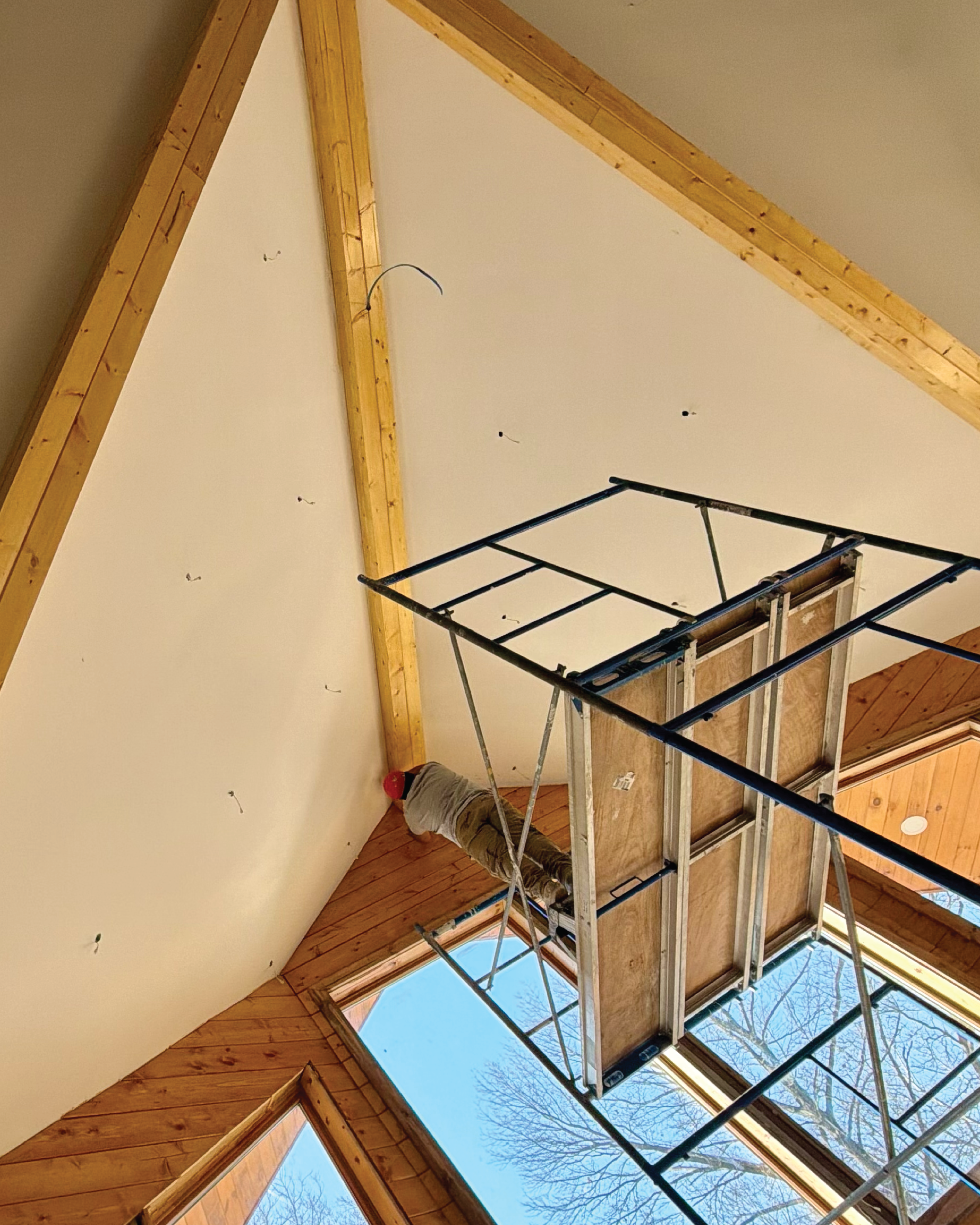 Residential home's interior full repaint and crew member staining beam