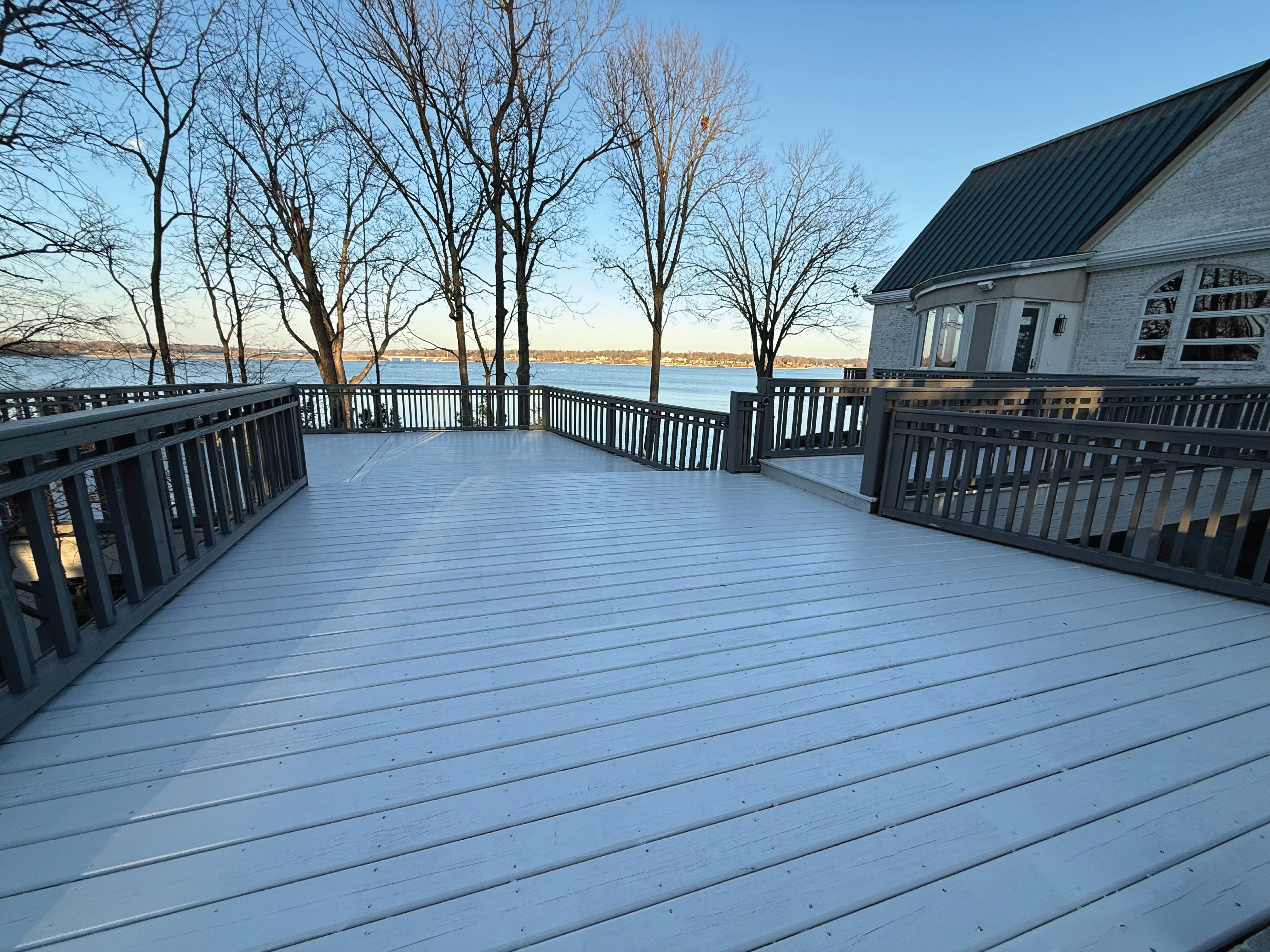 Deck solid color restain for a lake front residential home