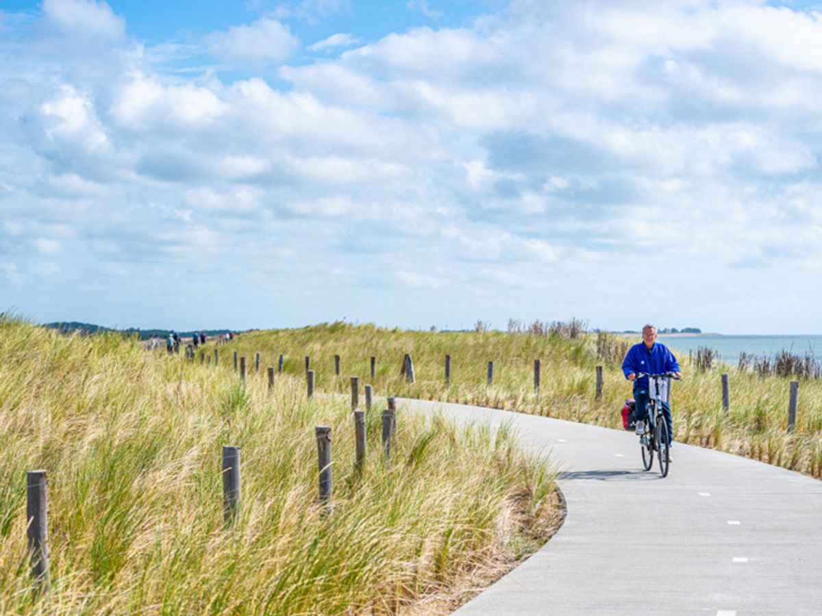cycling path through dunes alongside the Wadden Sea, on one of the Dutch Wadden Sea Islands