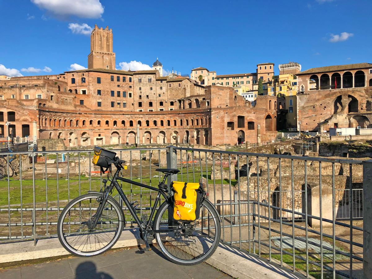 a bicycle parked in front of the Markets of Trajan (Mercati di Traiano) in Rome, Italy