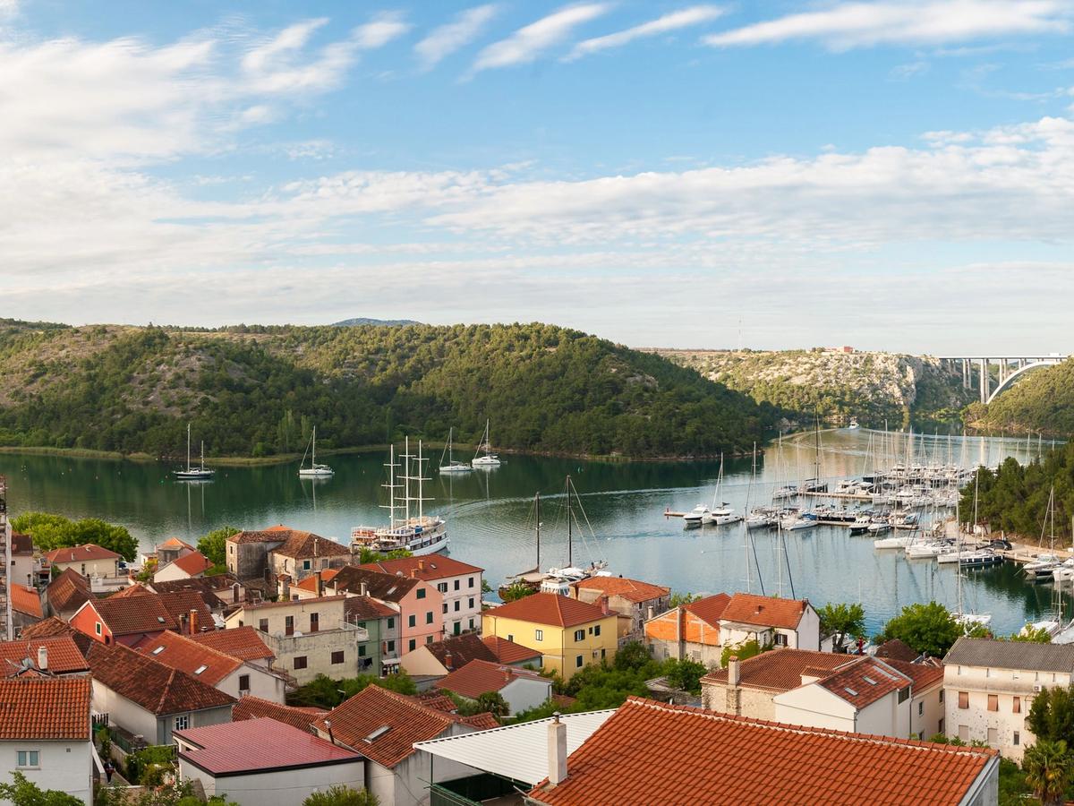 picturesque coastal town with a harbor filled with boats and surrounded by hills in NAD Island Solta Kaperna, Kapernak on Šolta Island, Croatia