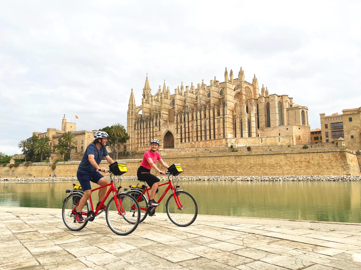 Cycling past Palma Cathedral on holiday