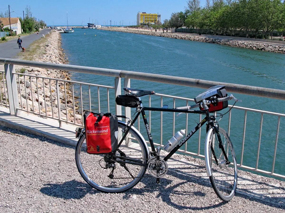 a Gazelle bicycle parked on a bridge overlooking a canal or waterway