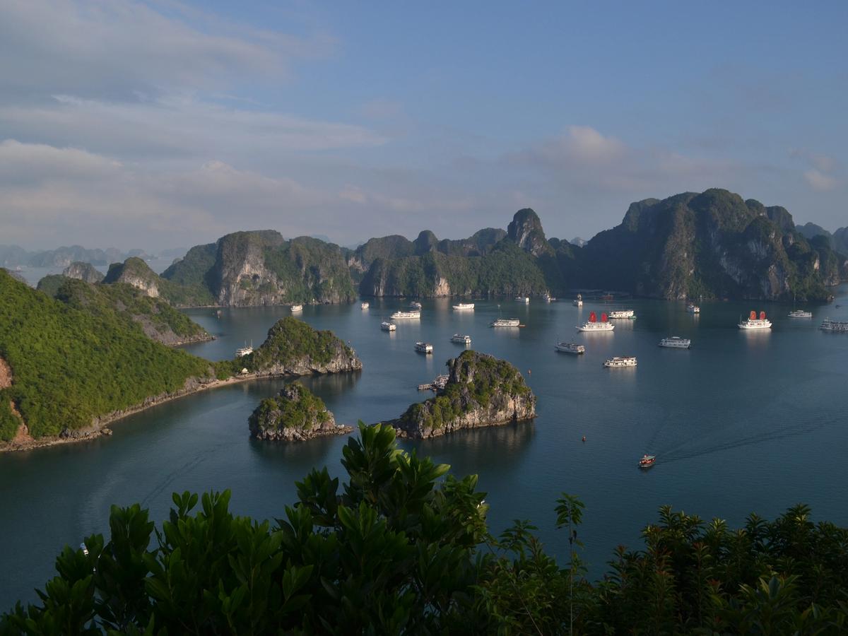 the iconic Ha Long Bay in Vietnam, a UNESCO World Heritage site renowned for its stunning limestone karsts and emerald waters. 
