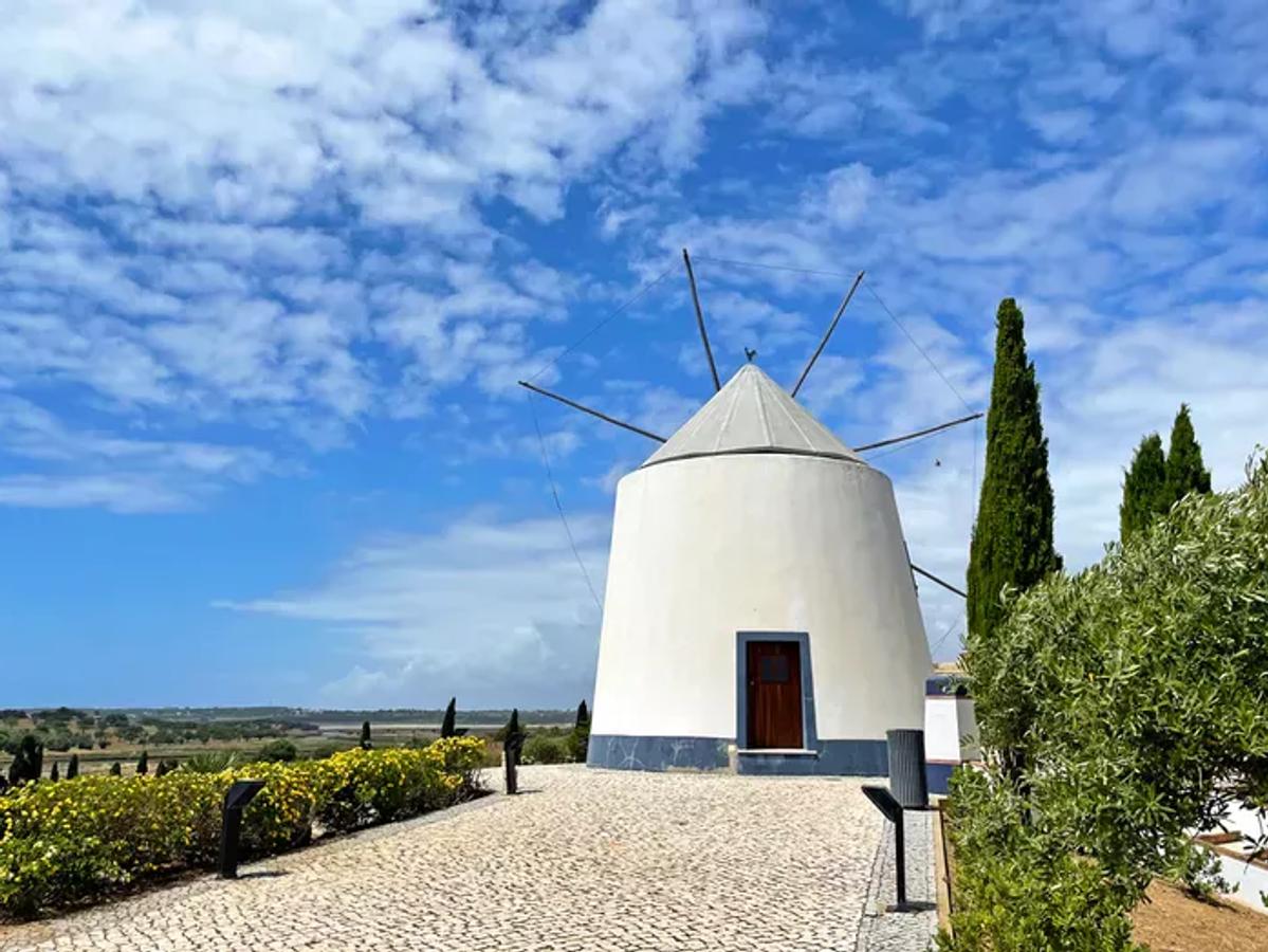 a traditional white windmill located on a hilltop in Castro Marim, Algarve, Portugal