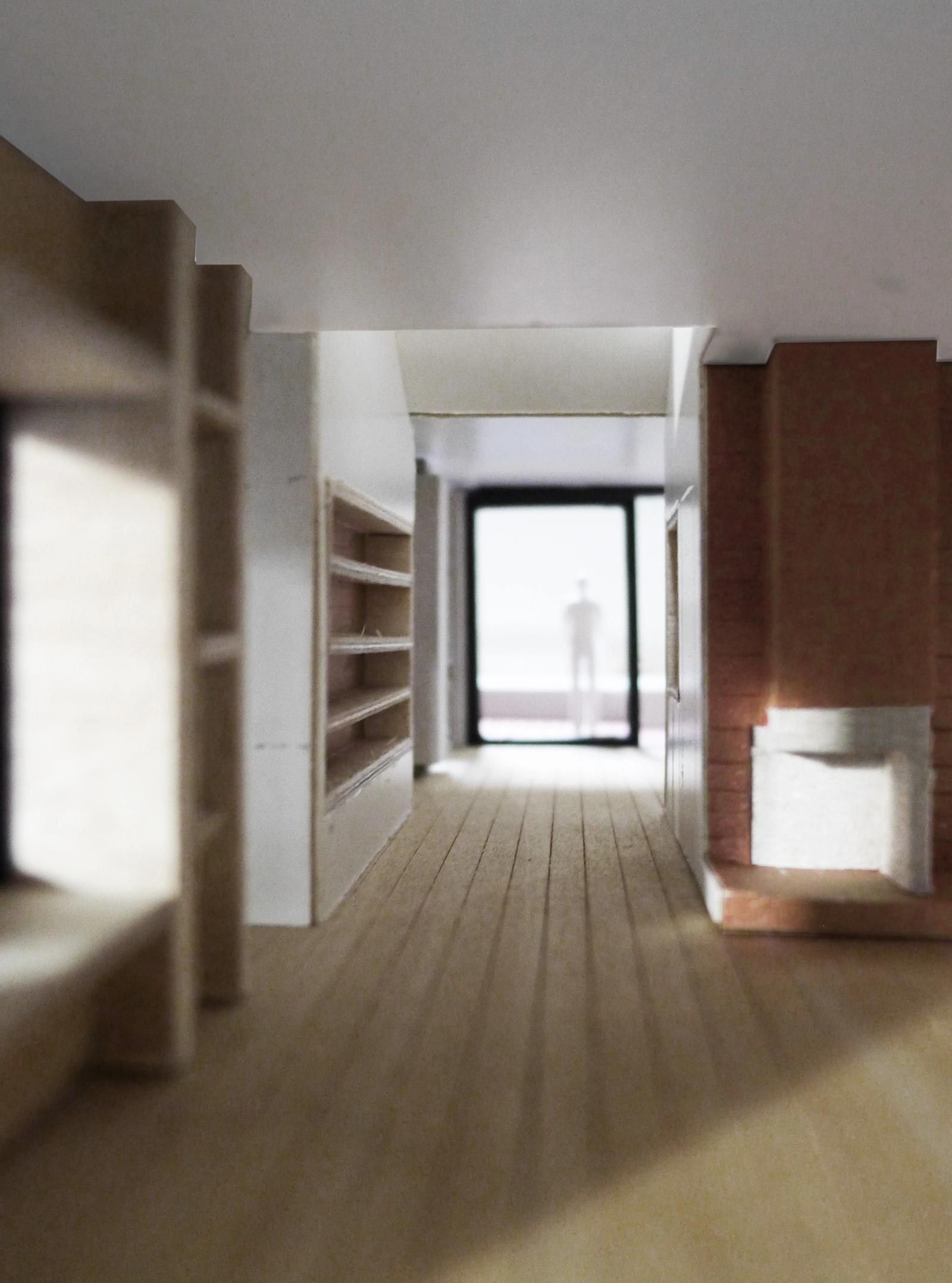 Long corridor ending at the brick fireplace and terrace door