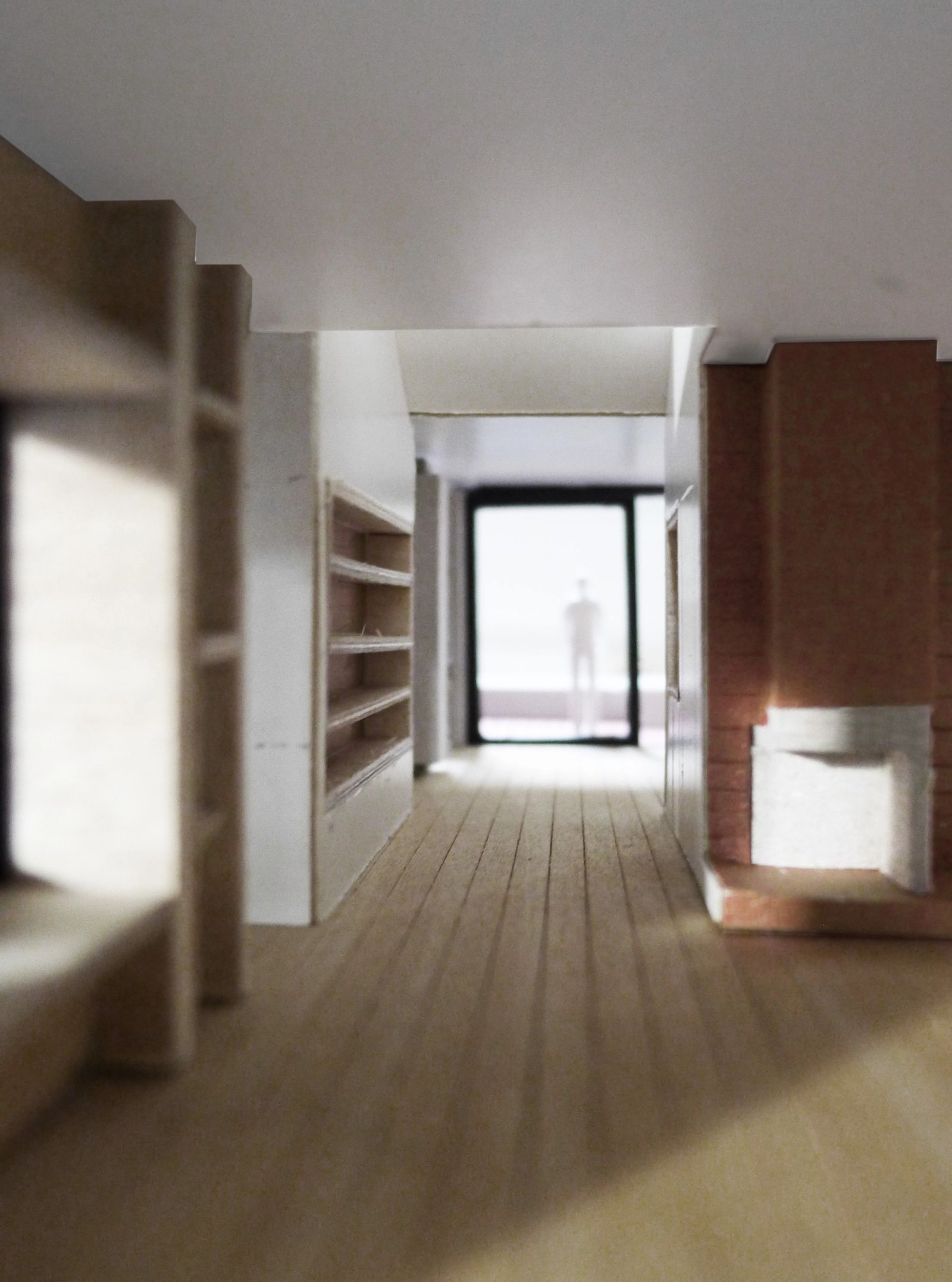Long corridor ending at the brick fireplace and terrace door