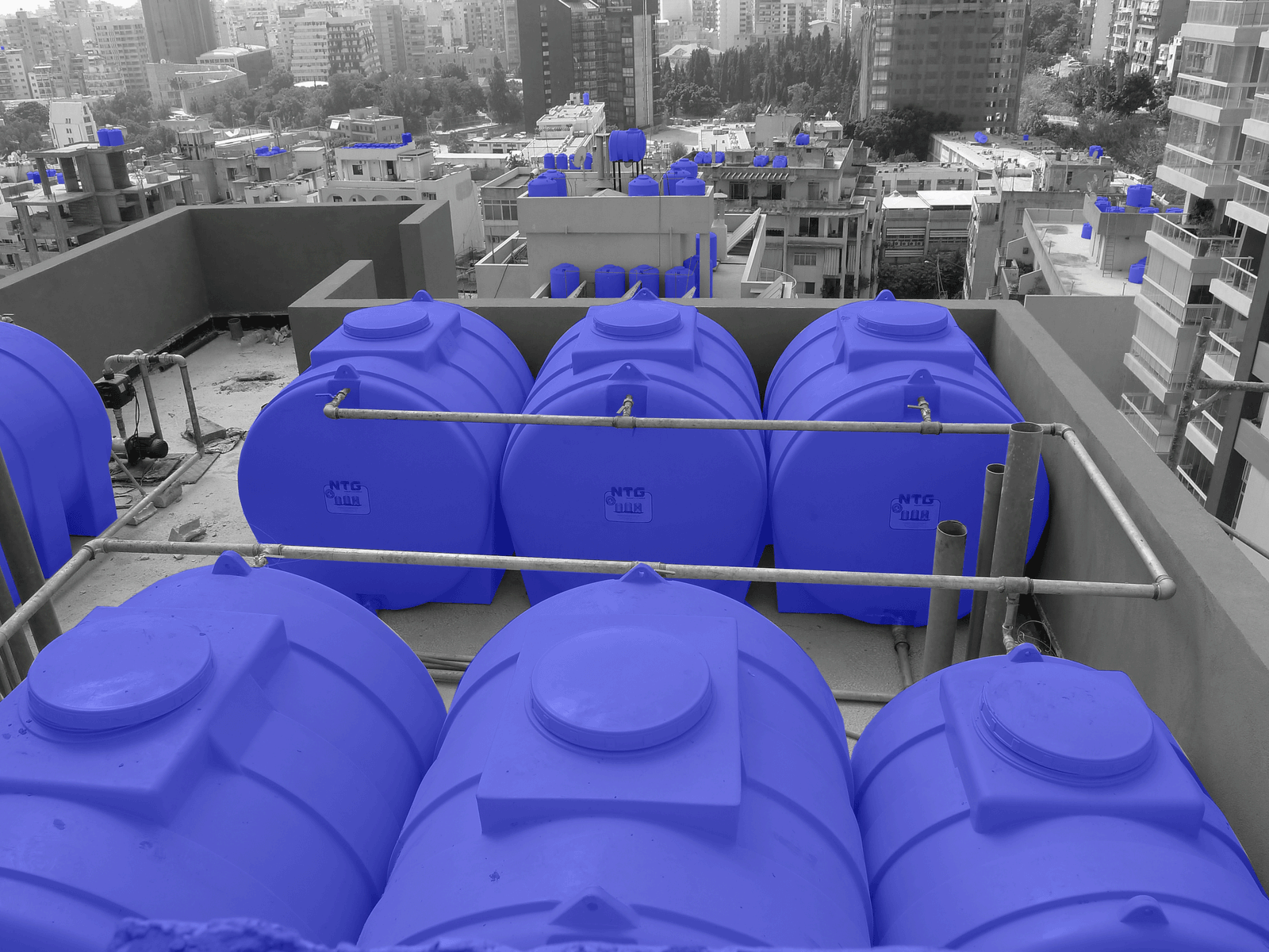 Rooftop photograph with new water tanks highlighted in blue