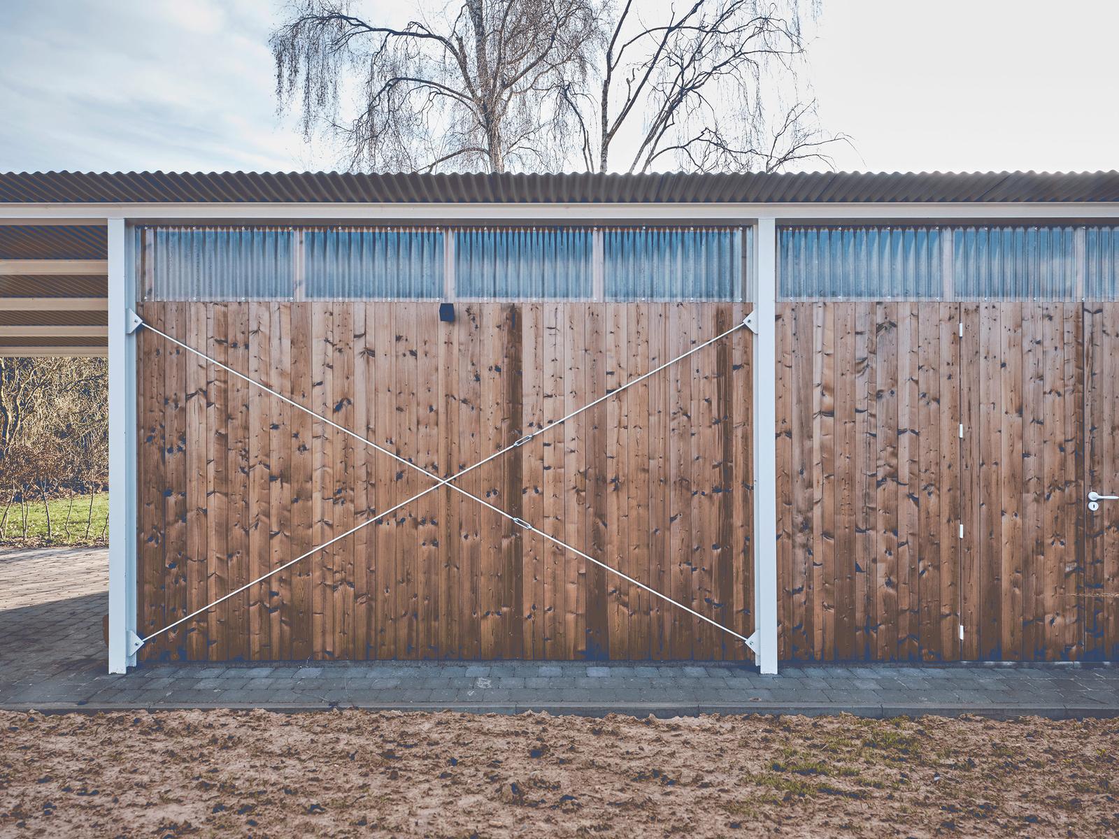 Large timber sliding doors closing the garden outbuilding
