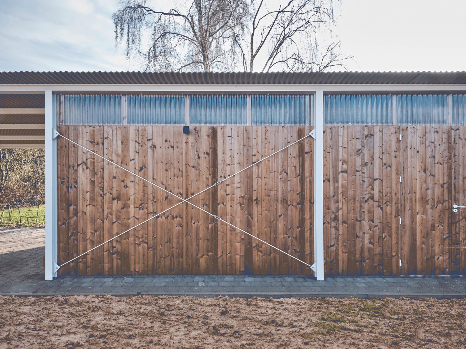 Large timber sliding doors closing the garden outbuilding