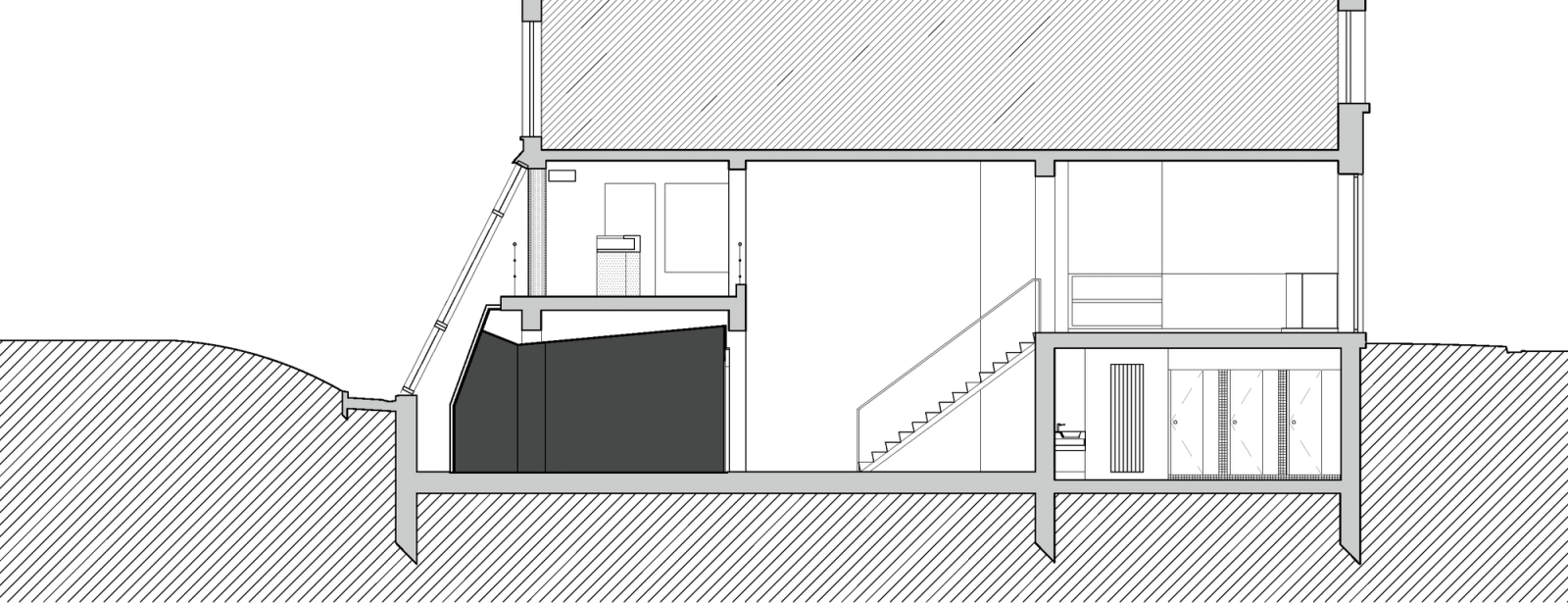 Section through the gym, entrance level and roof-lit upper floor