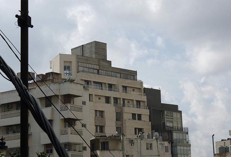Existing stepped apartment building seen from the street