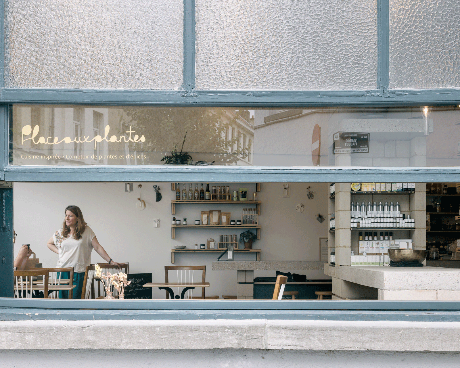 Shop interior and communal table seen through the open window