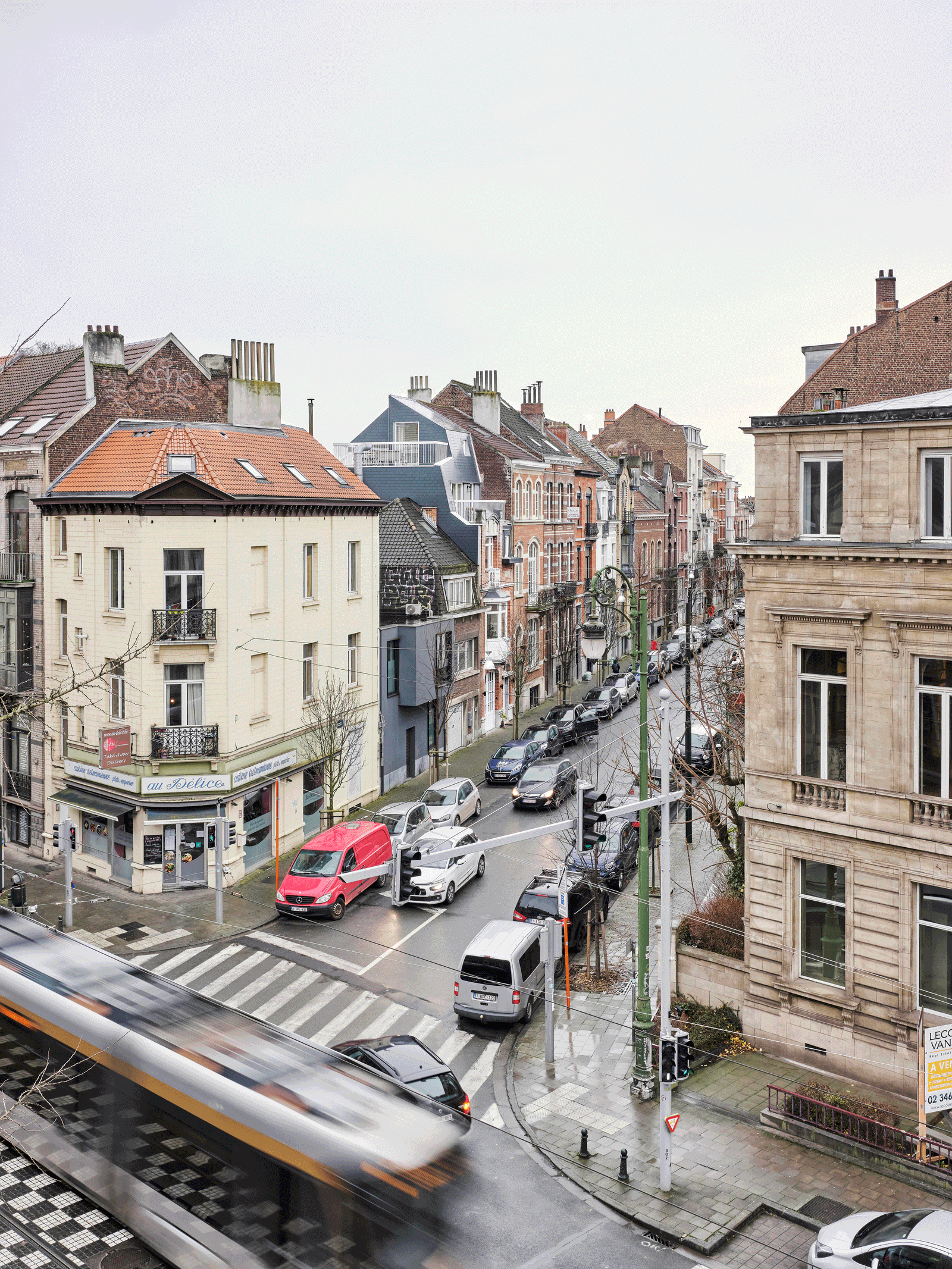 View from an upper window across a tram-lined city street