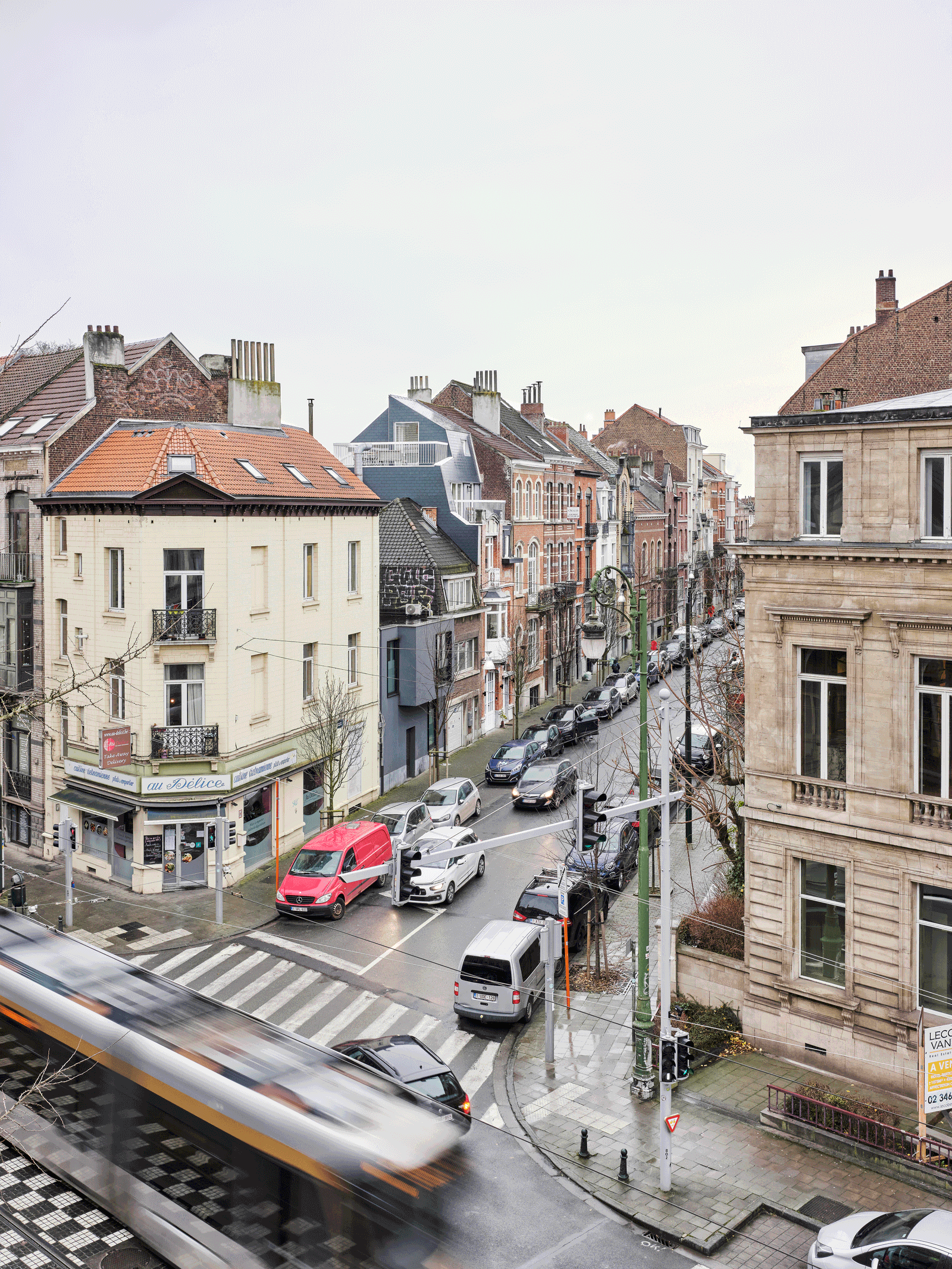 View from an upper window across a tram-lined city street