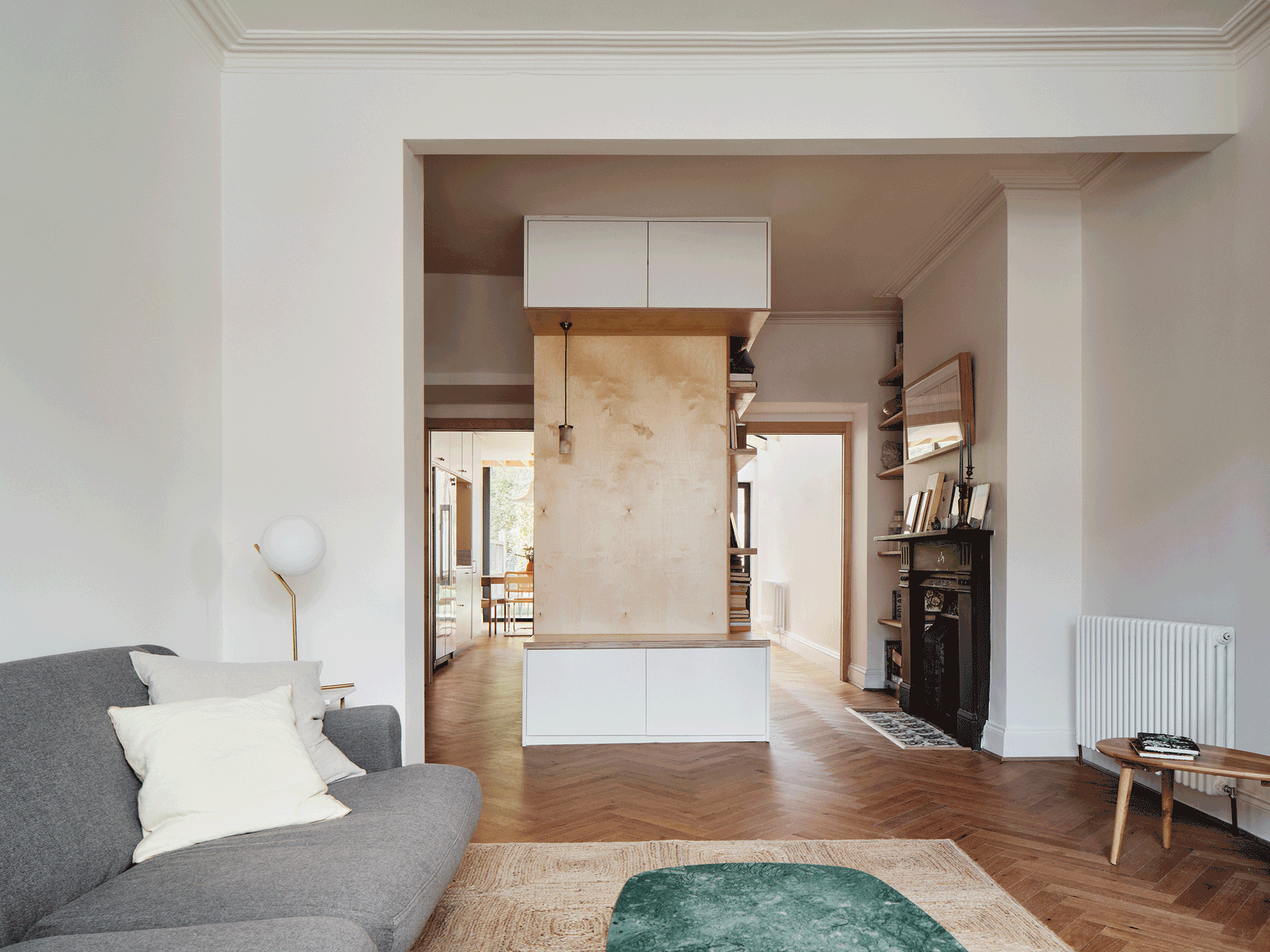 Living room opening through to the kitchen and garden