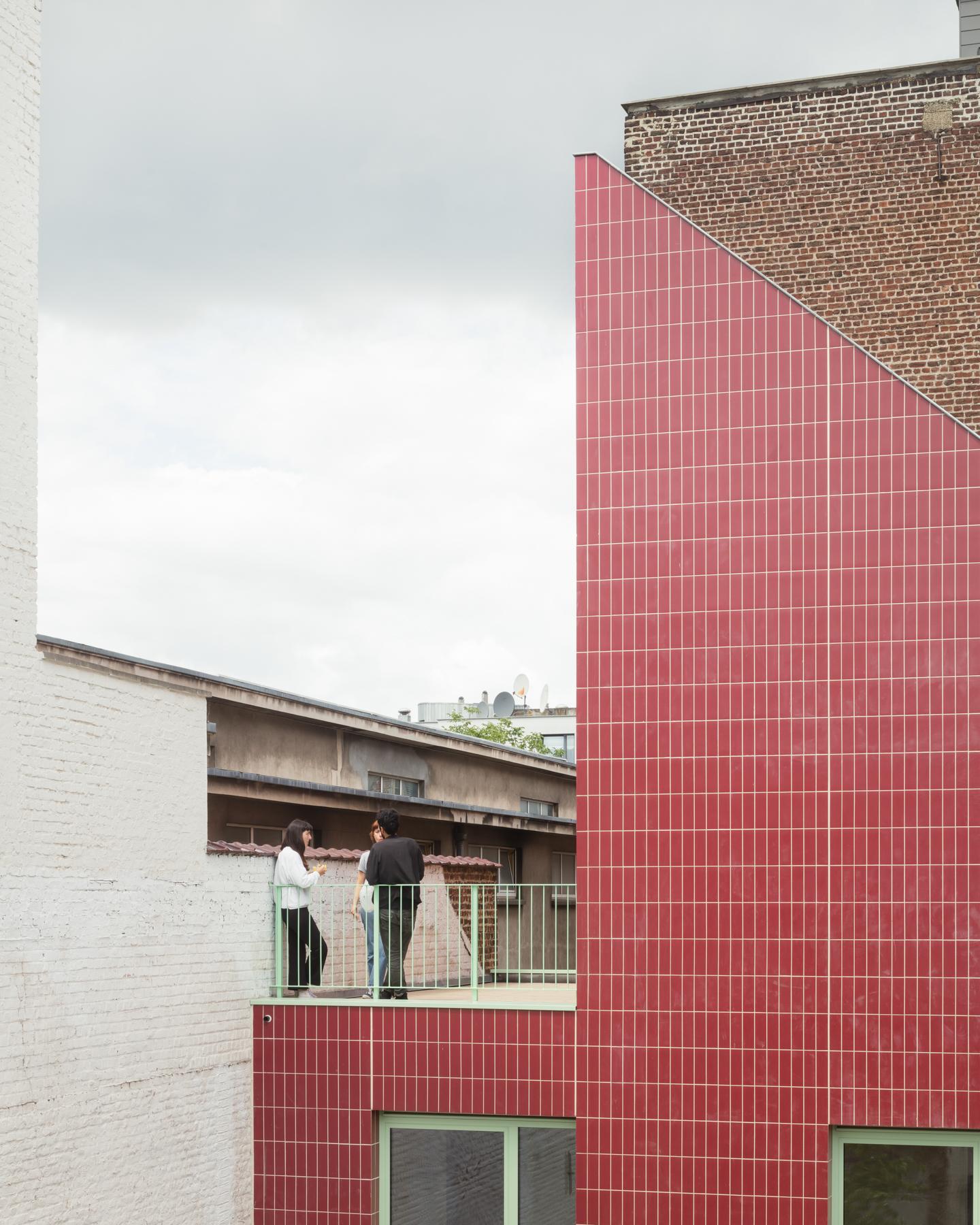 Close exterior view of the red-tiled gabled housing addition