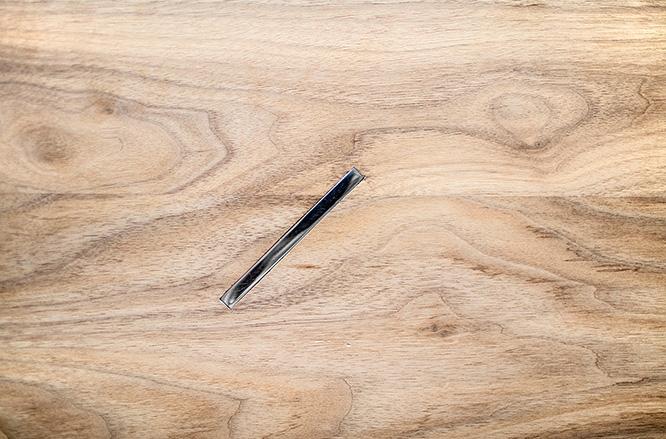 Close view of the timber tabletop and recessed dark fitting
