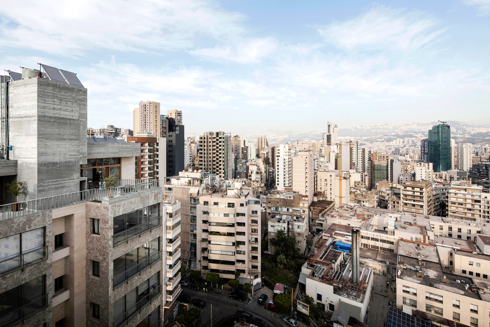Dense city skyline viewed from the unfinished rooftop