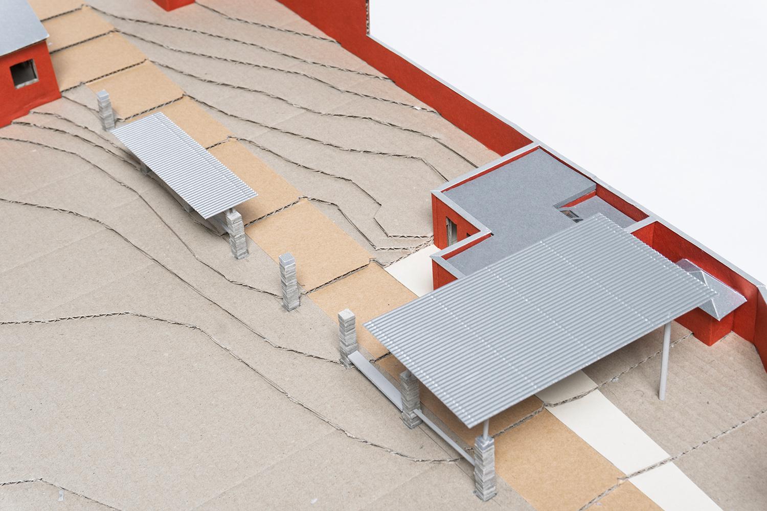 Physical model of a covered structure beside the play yard