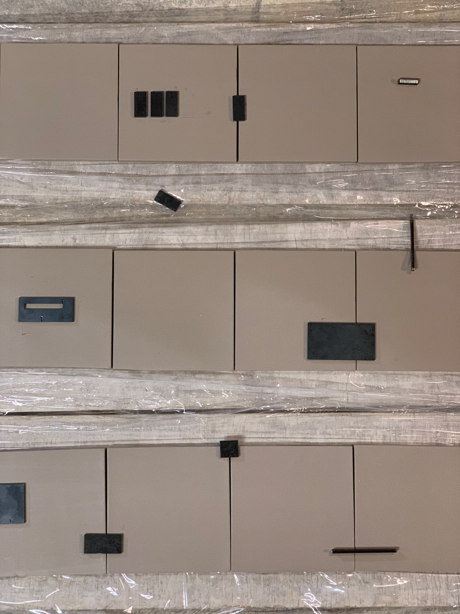 Close view of metal panels, fasteners and inset openings