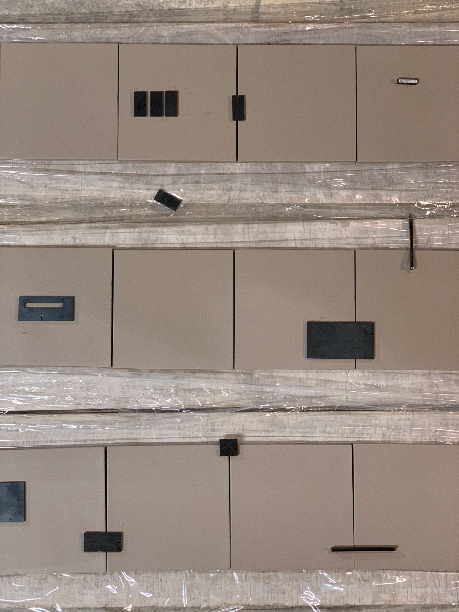Close view of metal panels, fasteners and inset openings